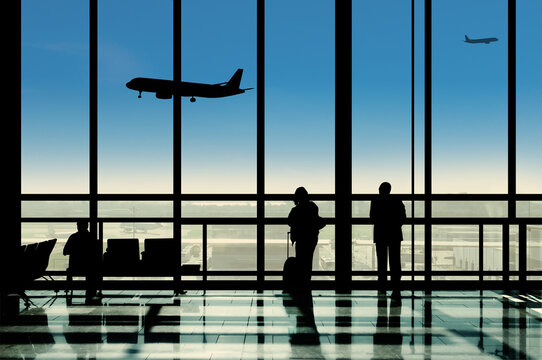 Silhouette In The Airport Terminal Lounge Viewing Planes