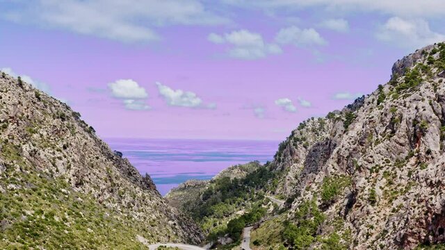 aerial view of the mountains of Mallorca with pink sea and pink sky, Estellencs, Mallorca, Spain
