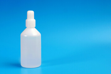 white plastic medicine bottle on blue background with a copy space