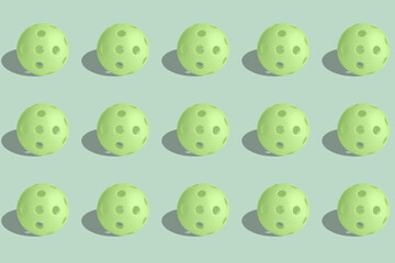 Pattern green pickalball balls on a pastel green background.