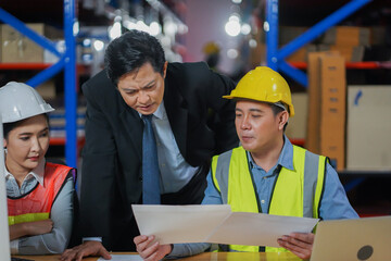Manager with worker team working warehouse. During working hours in the warehouse, there is a checking, checking, stock for quality products, safe for customers. Women worker in warehouse concept.