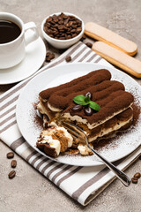 portion of Classic tiramisu dessert and savoiardi cookies on concrete background
