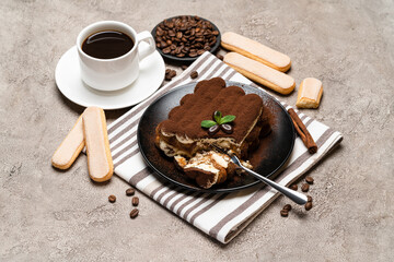 portion of Classic tiramisu dessert and savoiardi cookies on concrete background