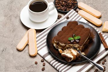 portion of Classic tiramisu dessert and savoiardi cookies on concrete background