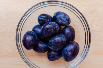 A bowl of plums above photo