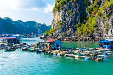 Floating village in Halong Bay, Vietnam. - obrazy, fototapety, plakaty