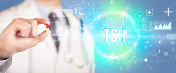 Close-up of a doctor giving you a pill with TSH abbreviation, virology concept