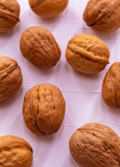 Ten walnuts lie on a white background close-up