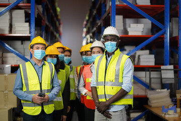 Warehouse manager, working team to wear a face to prevent COVID 19. Team Cooperative Organization