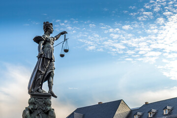 Frankfurt / Main, Germany - September 03rd 2020: A german photographer visiting the so called Römerplatz during a sunny day in summer. View to some roofs and the top of the fountain.