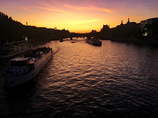 Naklejka premium A view of the river Seine in Paris in the evening showing a sunset
