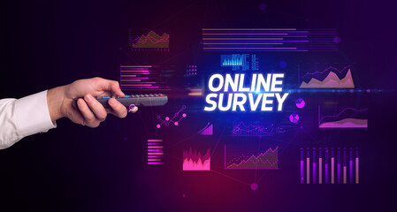 hand holding wireless peripheral with ONLINE SURVEY inscription, cyber business concept