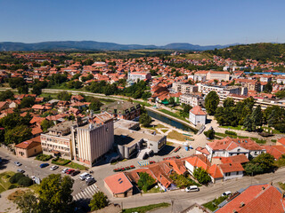Fototapeta na wymiar Top aerial view from drone on the buildings and houses in the city with river in sunny summer or autumn day - Knjazevac town in east Serbia cityscape