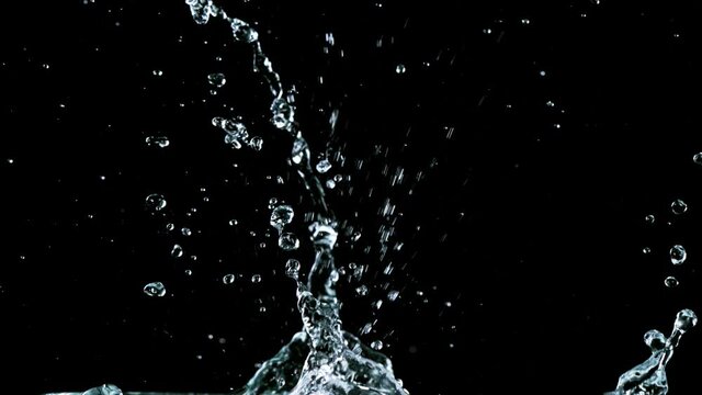 Water splashing on black background, super slow motion. Filmed on high speed cinema camera, 1000 fps.