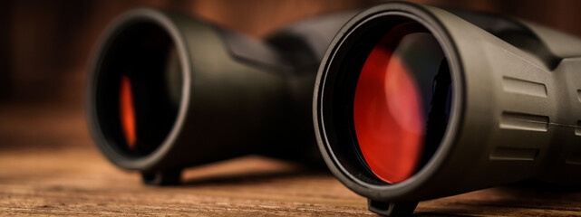 Banner army binocular on wooden table. Travel concept.