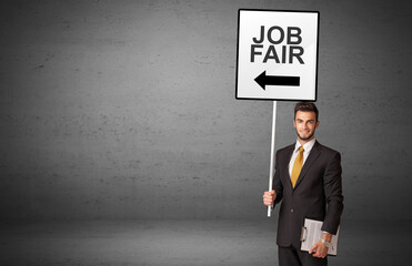 business person holding a traffic sign with JOB FAIR inscription, new idea concept