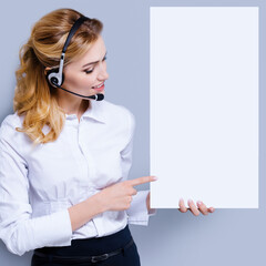 Call Center Service concept - customer support or sales agent. Businesswoman or caller or receptionist phone operator pointing at sign board with copy space. Helping, answering, consulting. Square.