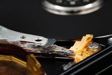 Disassembled laptop hard disk drive, hdd. Macrophoto. Opened hard drive, magnetic heads and disk...