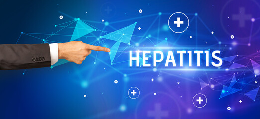 Close-Up of cropped hand pointing at HEPATITIS inscription, medical concept