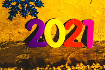 numbers 2021 new year different colors with holiday decoration on cement background 