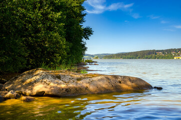 Shore of Lipno Lake with stones