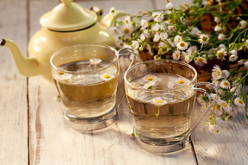 fresh chamomile tea on a wooden table