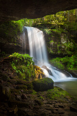Amazing beauty of scenic waterfall called Skok (The Jump) in village on Old mountain called Senokos, framed by rocks and surrounded by sunlit green plants © Nikola