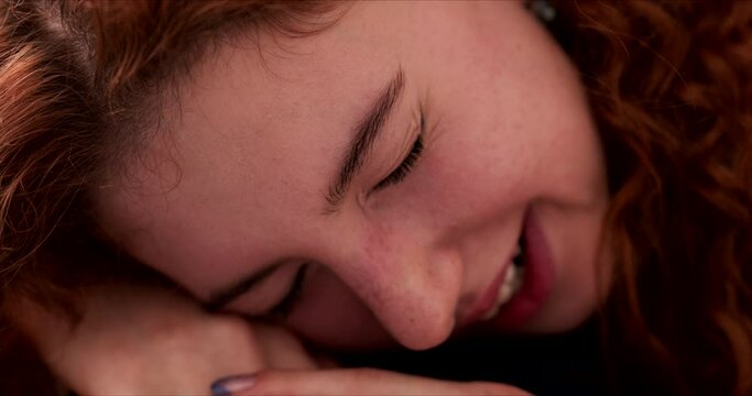 Tired young woman sleeping dozing with head on hands, yawning. Close up of females face asleep.