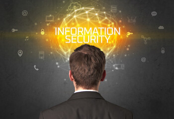 Rear view of a businessman with INFORMATION SECURITY inscription, online security concept