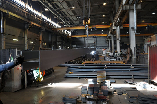 Transportation Of The Welded Girder By Means Of A Girder Crane In The Workshop At The Factory.