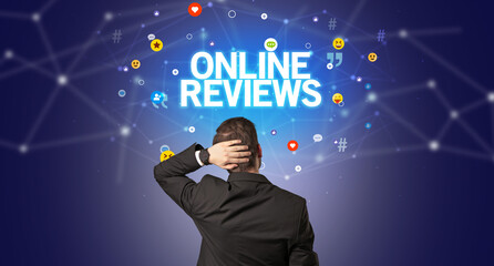 Rear view of a businessman with ONLINE REVIEWS inscription, social networking concept