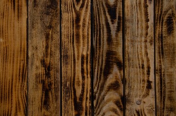 The texture of burnt wood. Pine wood background.
