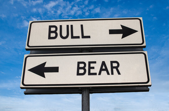 Bull vs bear. White two street signs with arrow on metal pole with word. Directional road. Crossroads Road Sign, Two Arrow. Blue sky background. Two way road sign with text. - Powered by Adobe
