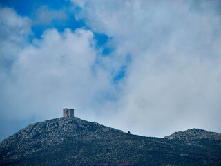 Fototapeta na wymiar clouds over a ruined castle in the mountains