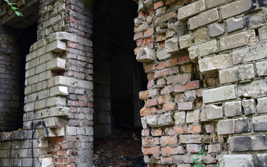 Abandoned brick building. A terrible house and crumbling walls.