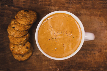 Closeup overhead shot of a coffee mug next to cookies