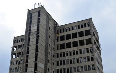 Fototapeta premium Abandoned residential building. An old high-rise building.