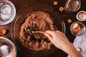 Mixing melted chocolate and cocoa powder in large bowl