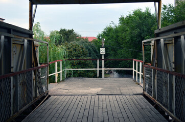 Fototapeta premium Wooden old bridge over the railroad tracks. Boards.