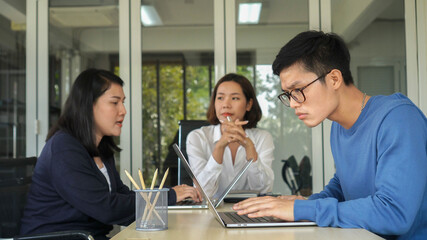 close up on group of asian employee man and woman meeting together n board room to consulting about new project or planning marketing strategy for business and teamwork concept