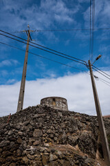 view of two old electric poles in azores. portugal