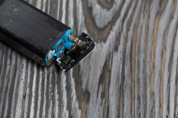 Corroded used batteries. On pine boards. Disposal of hazardous waste.