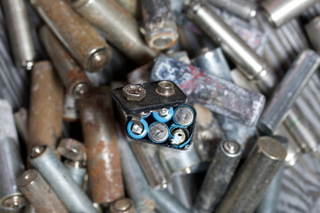 Corroded used batteries. On pine boards. Disposal of hazardous waste.