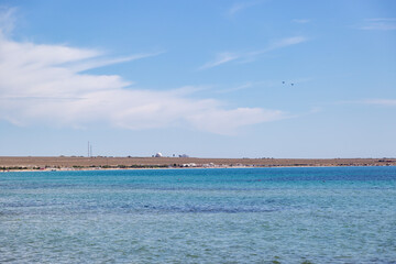 two military aircraft in the sky over the coastline