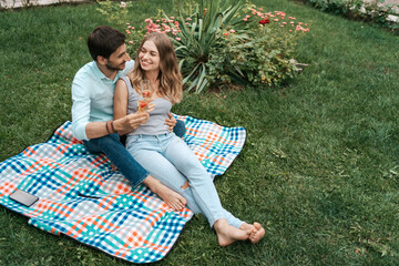 Summer holidays, people, romance, dating concept, couple drinking sparkling wine while enjoying...