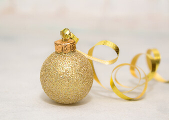Christmas and New Year composition with golden ball on a white wooden background