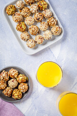 energy protein balls made with dry apricots, raisins, dates, walnuts, sunflower seeds, pumpkin seeds, sesame with orange juice