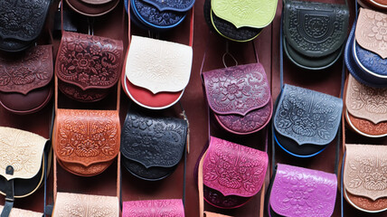 Souvenir market in Yaremche. Women's colored leather shoulder bags embossed with a Carpathian pattern. Bags and accessories on sale. 