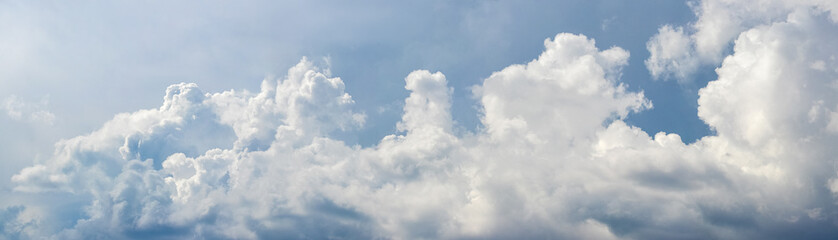 Panorama of blue sky with white clouds in light tones