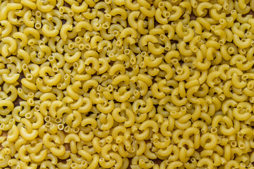 Full background of dry uncooked macaroni pasta